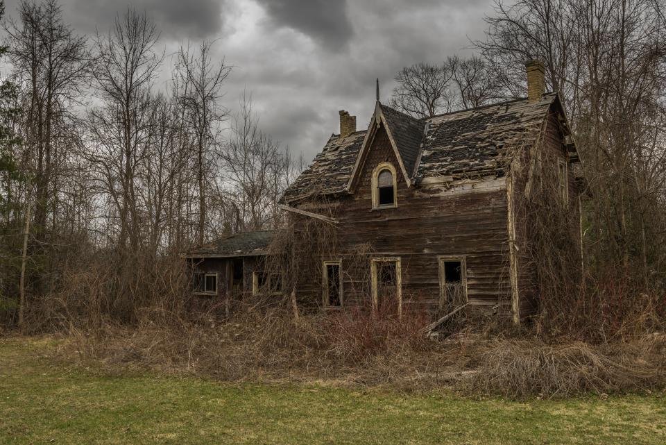 Old abandoned house surrounded with overgrown shrubs and trees | Shutterbug